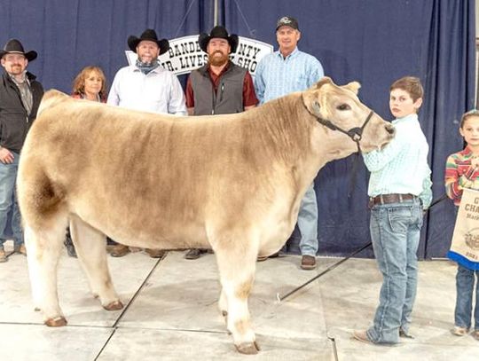 Cooper Arnold (second from right) displays the Grand Champion Steer he presented at the 2021 Bandera County Junior Livestock Show auction. The steer drew a top bid of $10,000. BULLETIN PHOTO