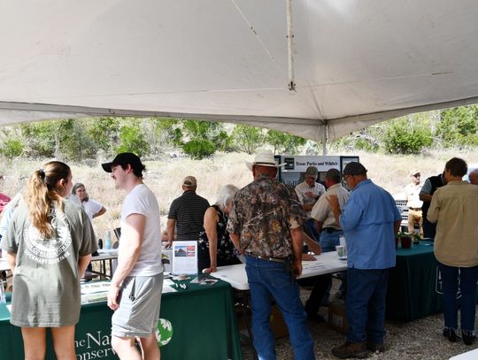 Attendees at the Bandera Canyonlands Alliance Meeting and Barbecue stroll among booths from various local environmentalist organizations. BULLETIN PHOTO/Tracy Thayer