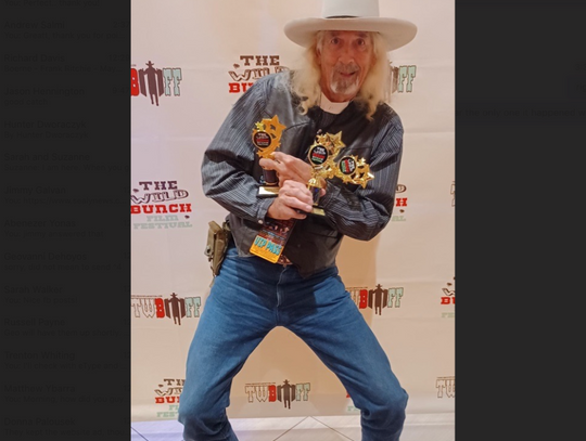 Bandera local Dennis Allyn hoists the three trophies he took home from the 2023 Wild Bunch Film Festival in Oct. 2023. Courtesy photo